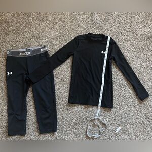 Under Armour Black Top with Red and White logo. Just right to wear for sports.